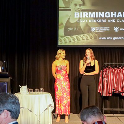 Two women standing on a stage at an awards event